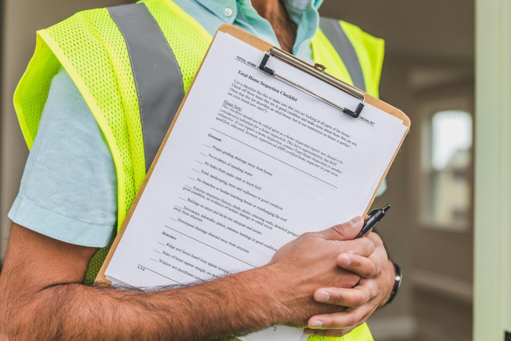 Contractor conducting a building inspection with a clipboard under Alberta asbestos regulations