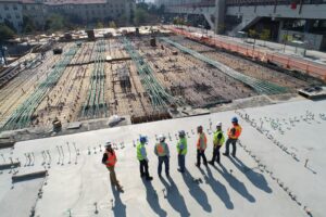 Construction workers reviewing a concrete building foundation at an active construction site in Calgary, Alberta