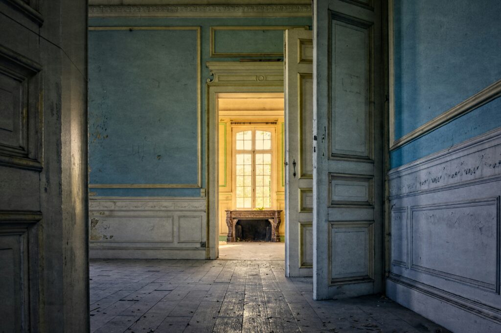 Interior of older home with open doorways and worn walls, representative of pre 1990 properties that may contain asbestos materials